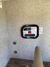 Control panel inside an RV rental: an Intelli-view digital tank monitoring system for battery and water levels.