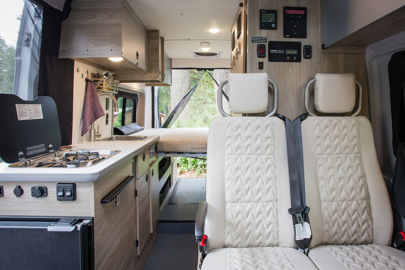  and open screened door looking out to trees and lush greenery.|Cozy rv rental interior: spacious bed — photo 15