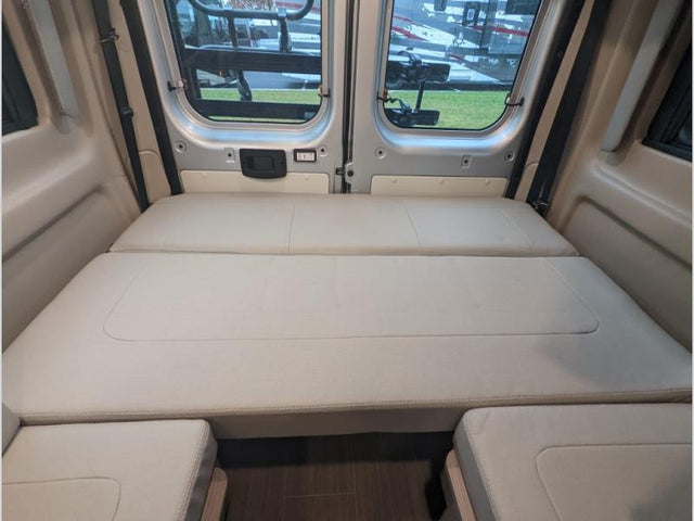  and a pop-top roof.|Bright camper van pop-top tent in an RV rental