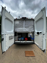 Ready for adventure! This rv rental's open back reveals custom storage, an outdoor shower, and a privacy curtain.