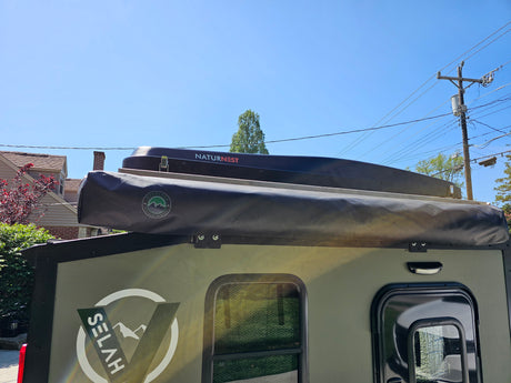 Get ready for adventure! This rugged Selah overland camper with a NaturNest rooftop tent and awning makes a great rv rental.