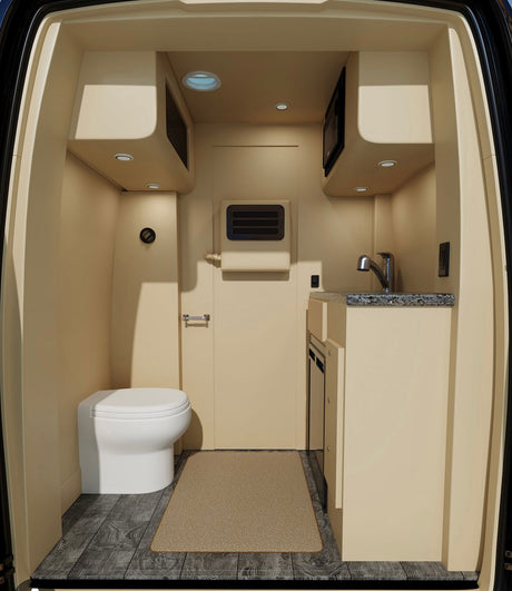 Compact RV rental interior with toilet, kitchenette (sink, microwave), and wood-look flooring. Perfect for travel.