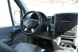 Inside a Mercedes Sprinter van, ready for your **rv rental** adventure. View of the dashboard, steering wheel, and media console.