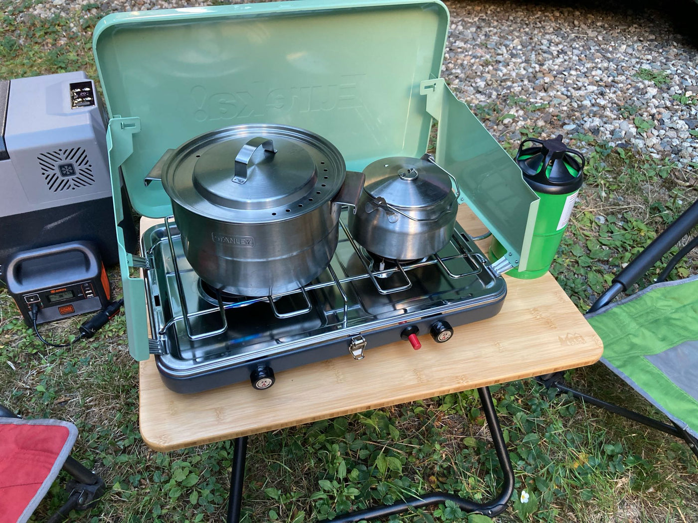Perfect for your RV rental adventure: Camping stove, pots, and portable fridge on a table for outdoor cooking. — photo 4