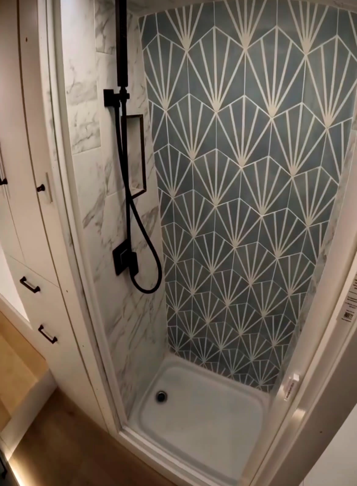 and a large white farmhouse sink. Bright LED lighting throughout.|Step inside this modern RV rental: a sleek van conversion featuring a compact shower — photo 4