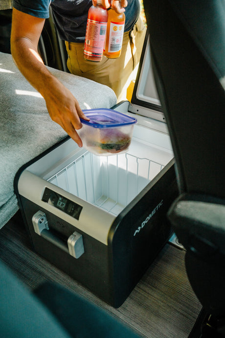 In an RV rental, a Dometic portable fridge helps store food & drinks, essential for road trip adventures.