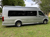 This sleek, silver Airstream Interstate Tommy Bahama Solar Edition rv rental is parked on grass, ready for adventure.