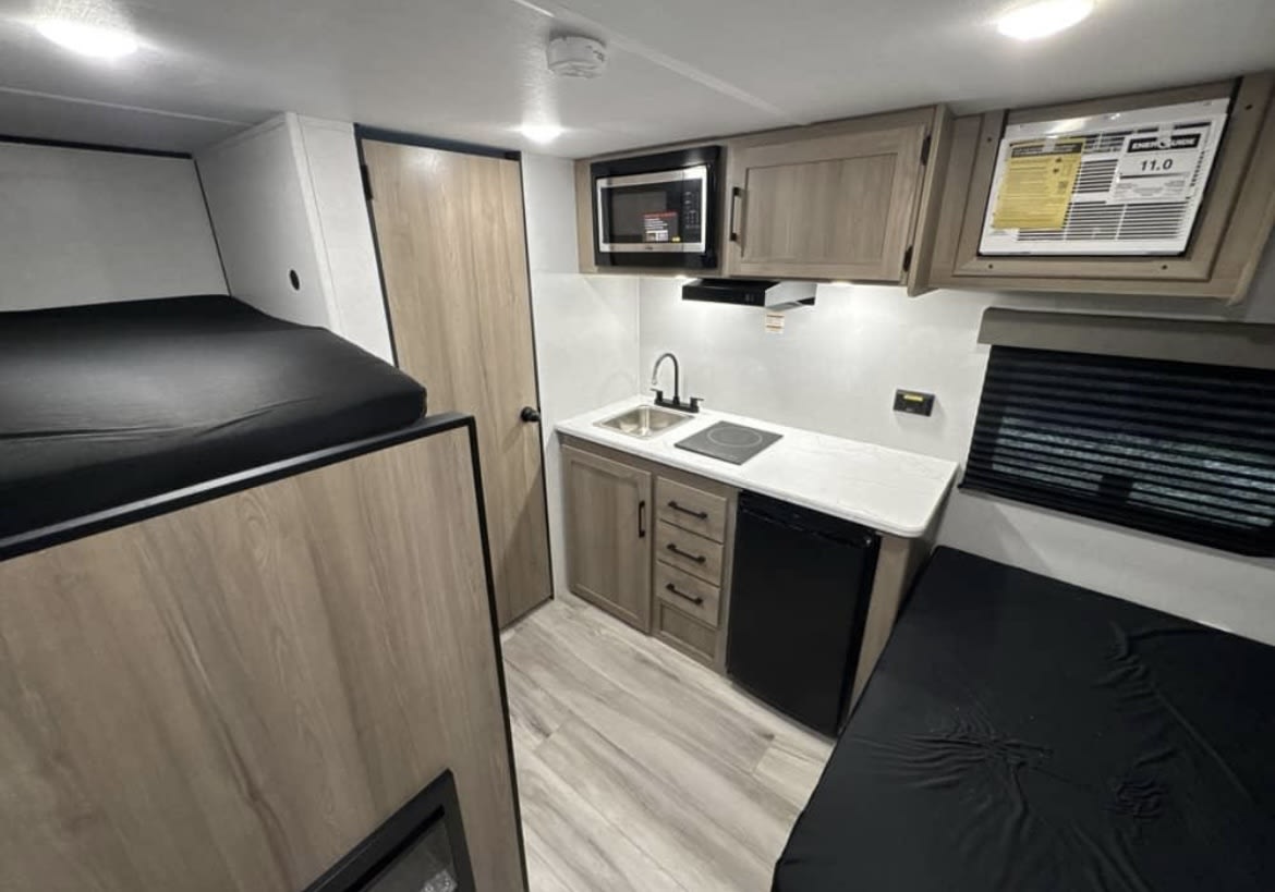 rv rental: Modern interior features bunk beds — photo 1