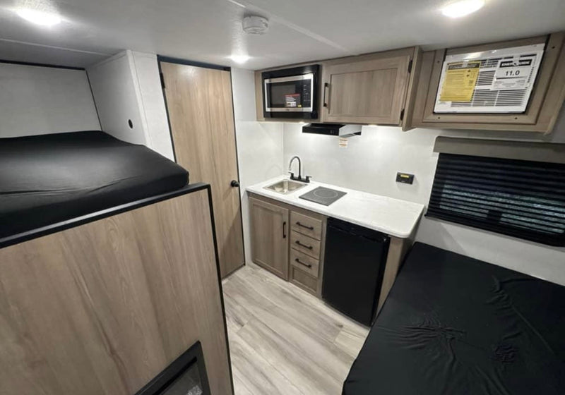 rv rental: Modern interior features bunk beds — photo 1