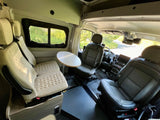 Spacious RV rental interior: swivel front seats, rear bench seating, and a dinette table for comfortable travel.