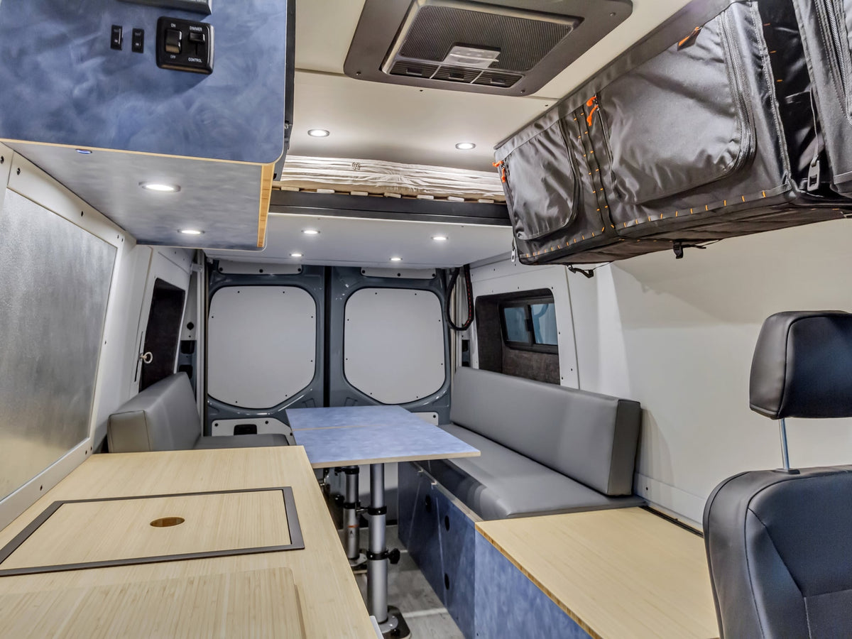  customized Mercedes-Benz Sprinter camper van rv rental with off-road tires and a roof rack is ready for adventure.|Modern RV rental interior with compact kitchen — photo 2