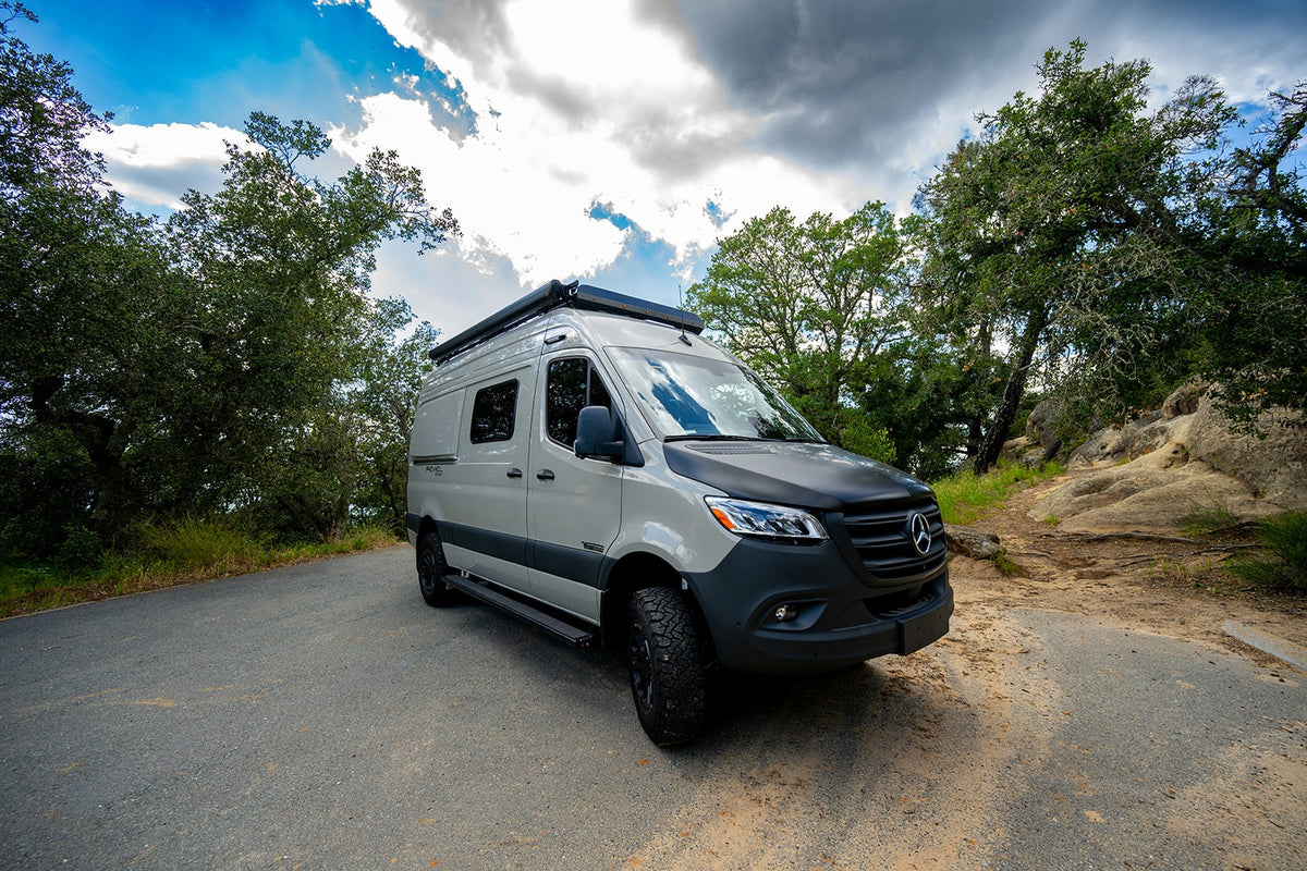 Ready for adventure! This custom Mercedes-Benz Sprinter rv rental is parked on a scenic road, surrounded by nature. — photo 2