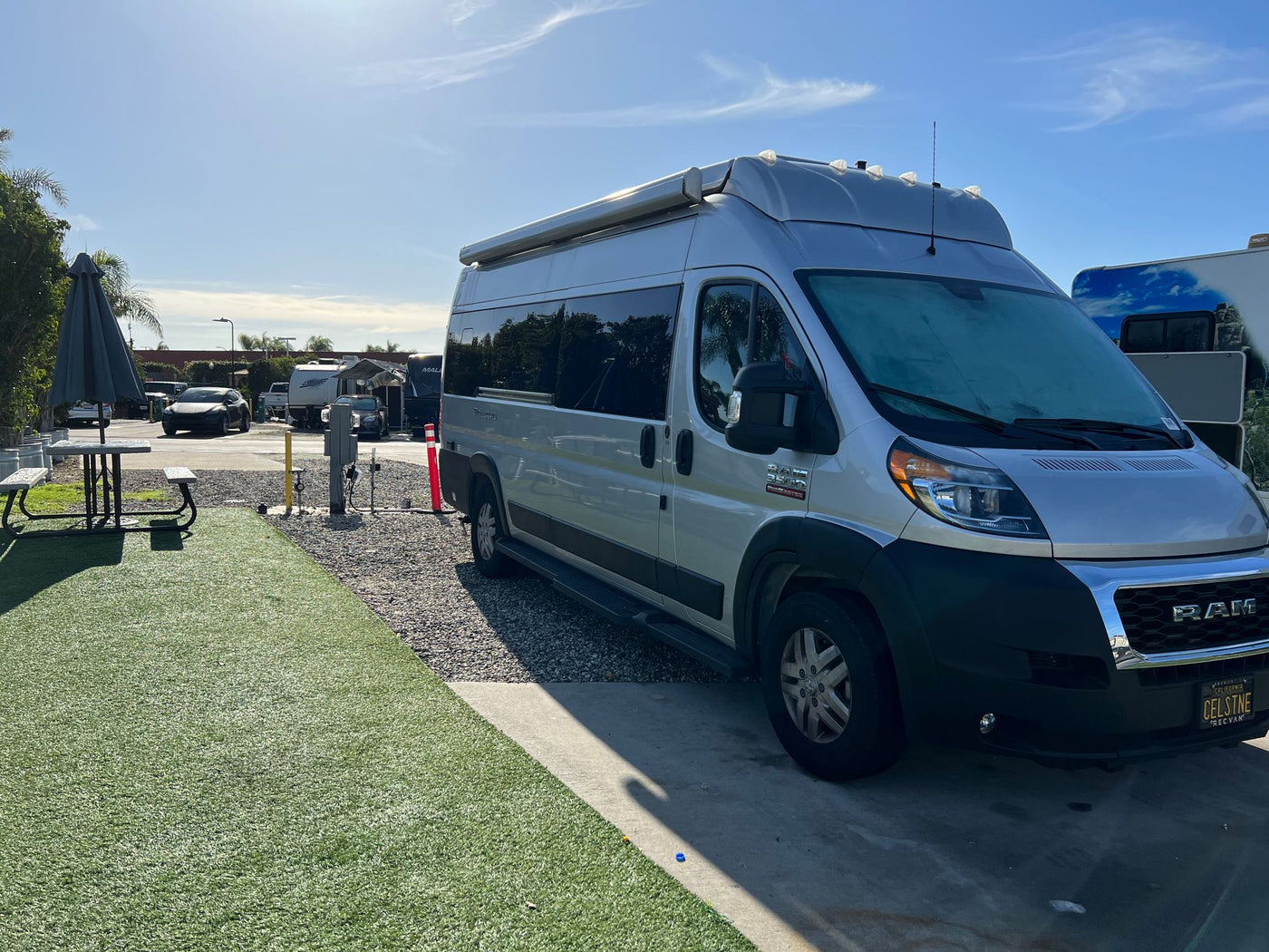  offering a compact dining/lounge area.|Compact RV rental kitchen interior: features a Dometic induction cooktop — photo 13