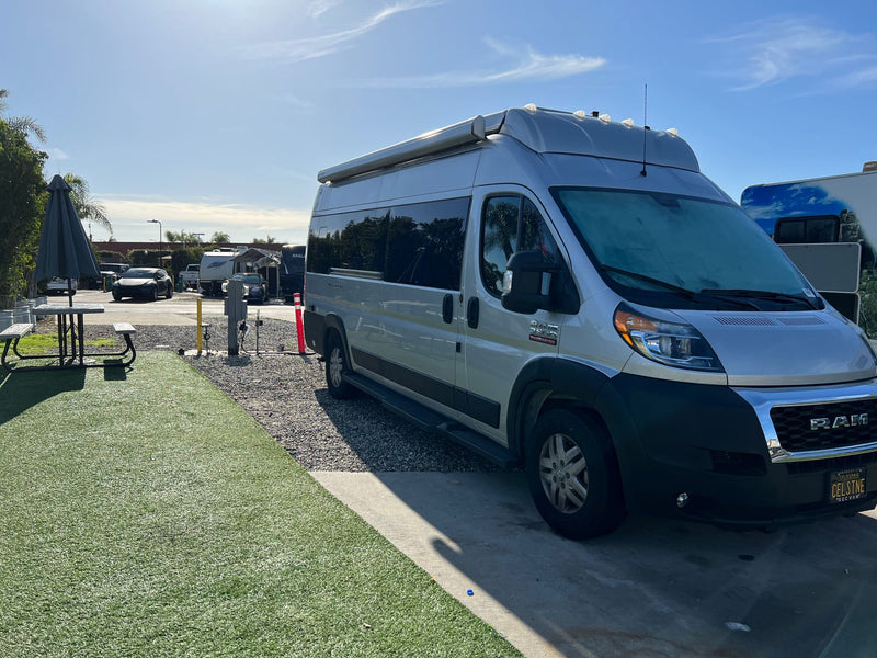  offering a compact dining/lounge area.|Compact RV rental kitchen interior: features a Dometic induction cooktop — photo 13