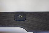 Close-up of a dual USB charging port with a yellow power indicator in an RV rental. Charge your devices easily.