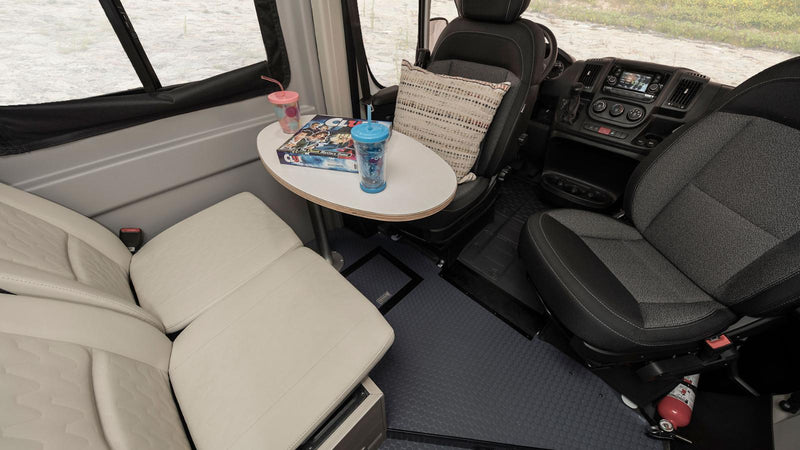  parked on a tree-lined street.|Inside an RV rental: Swivel front seats — photo 3