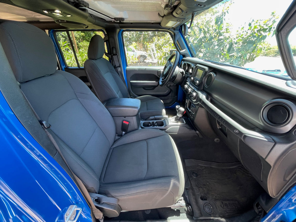 Spacious interior of a blue Jeep Wrangler, showing seats, dash, and controls. Great for trips, consider alongside an RV rental. — photo 6