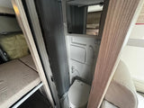 Explore this RV rental's compact interior: a functional bathroom with toilet, mirror, and shower, plus a cozy bunk bed.