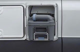 RV rental: Exterior access panel open, revealing the gray toilet waste cassette. Essential for sanitation & easy disposal during travel.