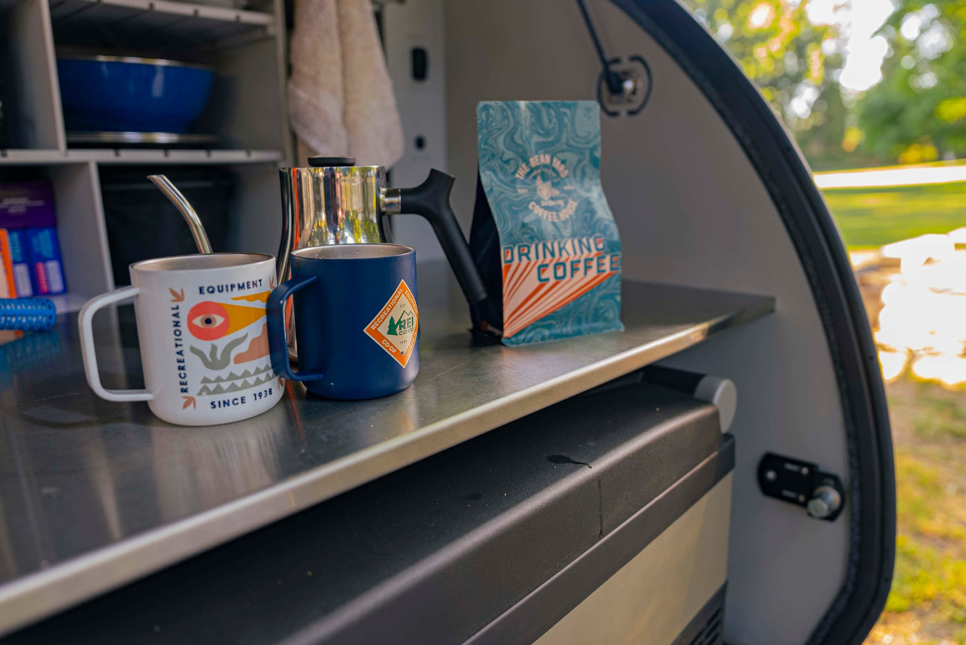  complete with mugs and a pour-over setup.|A close-up of coffee supplies inside an rv rental: a white mug — photo 4