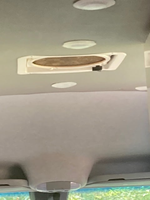 **RV rental** vehicle **ceiling** featuring a large **ventilation fan**, recessed **lighting**, and grey fabric **headliner**. — photo 13