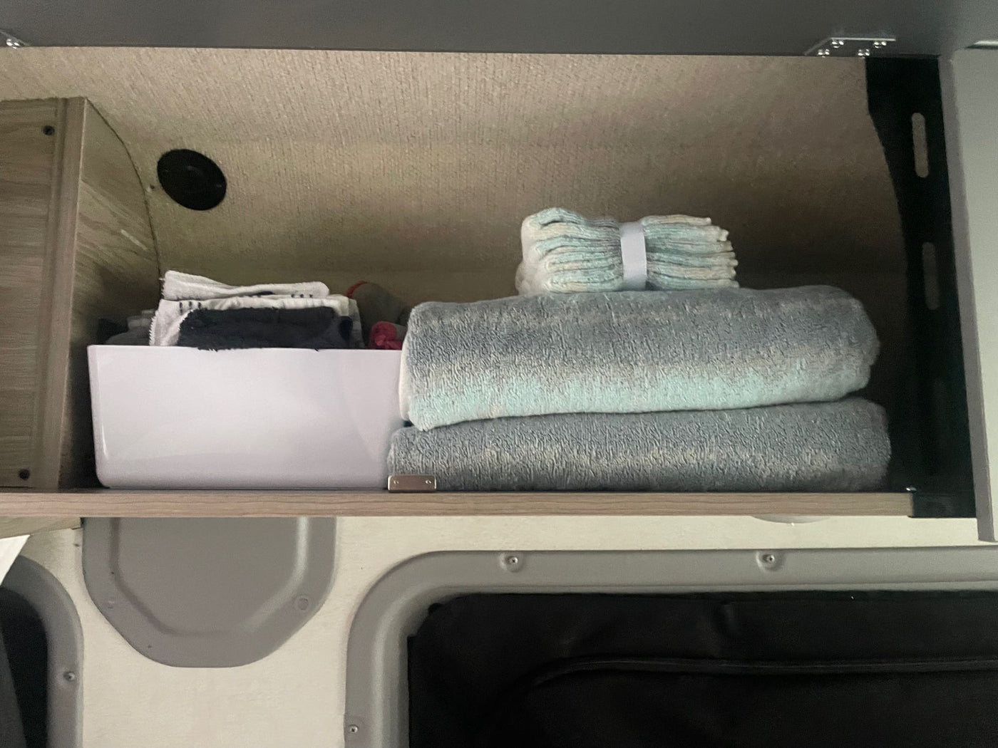  and forest backdrop at dusk.|An RV rental camper van with its side door open — photo 4