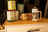 Trader Joe's teas, coffee, and a French press on a counter, perfect for morning brews in an RV rental.