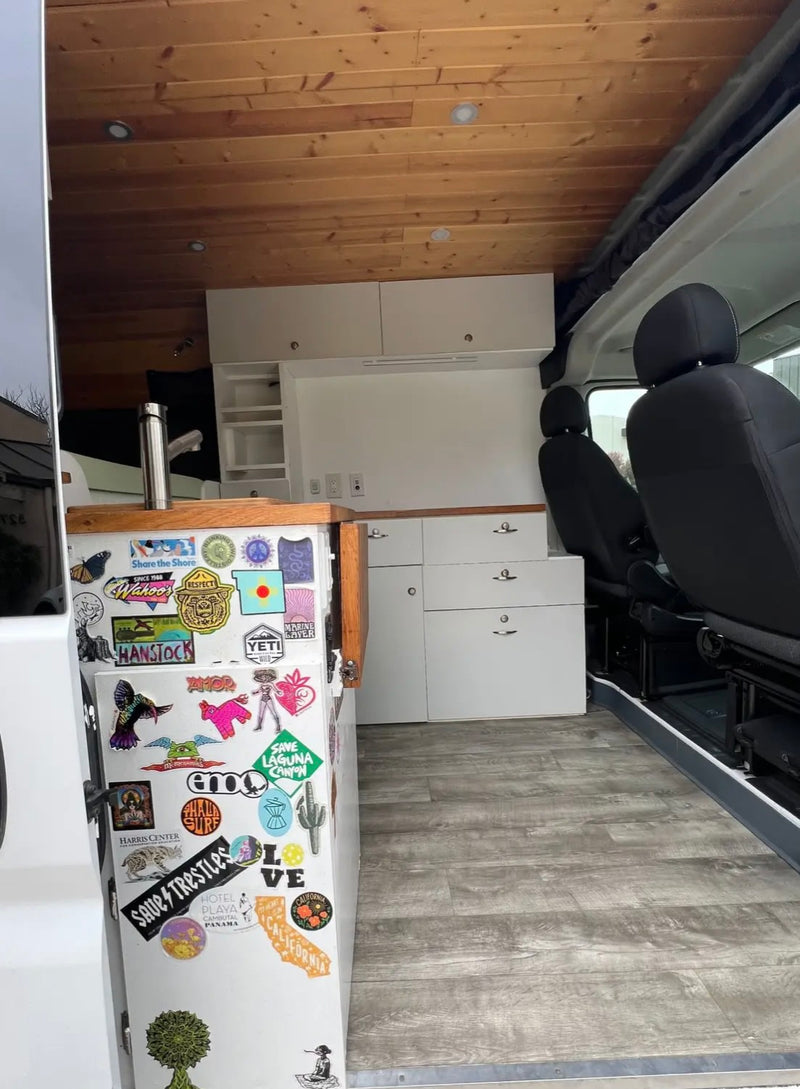  a Dometic CFX portable fridge with its lid open sits on a wooden floor — photo 5
