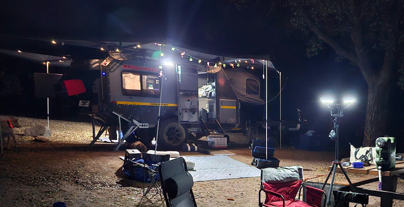 Nighttime off-road RV rental campsite: a well-lit Conqueror caravan with string lights and a cozy outdoor setup for adventure. — photo 17