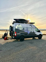 Adventure-ready custom van, great for rv rental, with kayak & paramotor for outdoor sports at sunset.