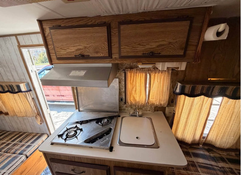  is an ideal rv rental for a retro camping adventure.|Vintage white Shasta travel trailer with orange stripes — photo 3