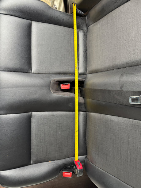 Measuring vehicle rear seat length (approx. 29+ inches) for an RV rental. Provides key dimensions for space planning.