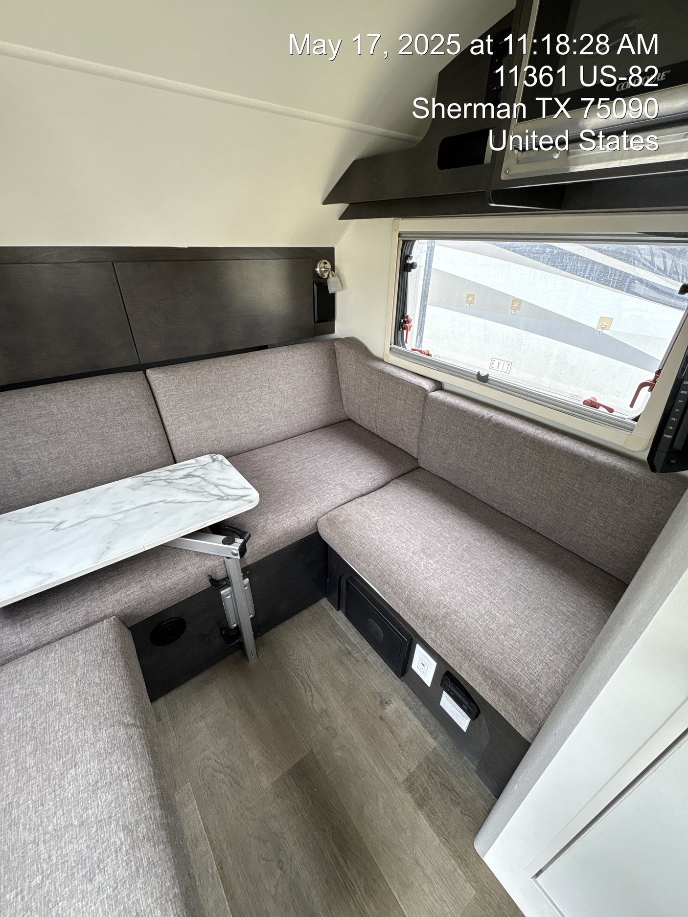 RV rental interior: cozy L-shaped dinette, adjustable table, and large window for scenic views on the road.