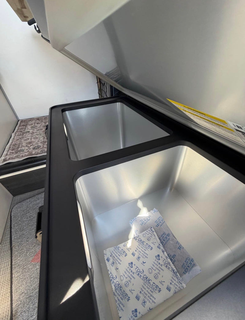  and overhead net.|Compact rv rental interior featuring a Dometic cooktop — photo 7