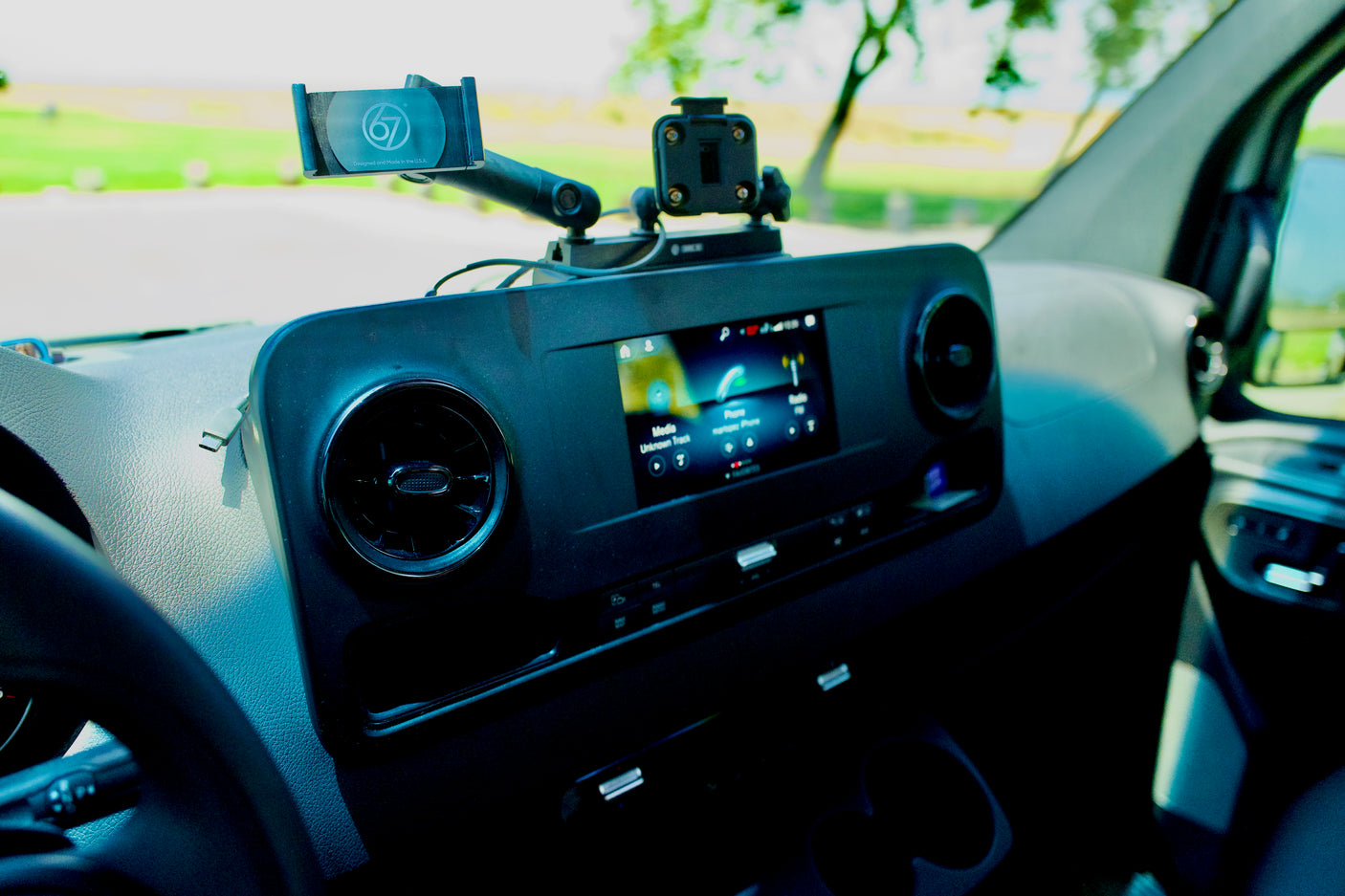 Modern RV rental dashboard shows infotainment screen, phone mount, and air vents, ready for adventure.