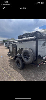Explore off-grid with this Boreas MXT overland camping trailer! Great for RV rental, featuring a rooftop tent & rugged tires.