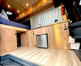 Experience this custom van conversion RV rental! Features a raised bed, compact kitchen, and smart storage solutions.