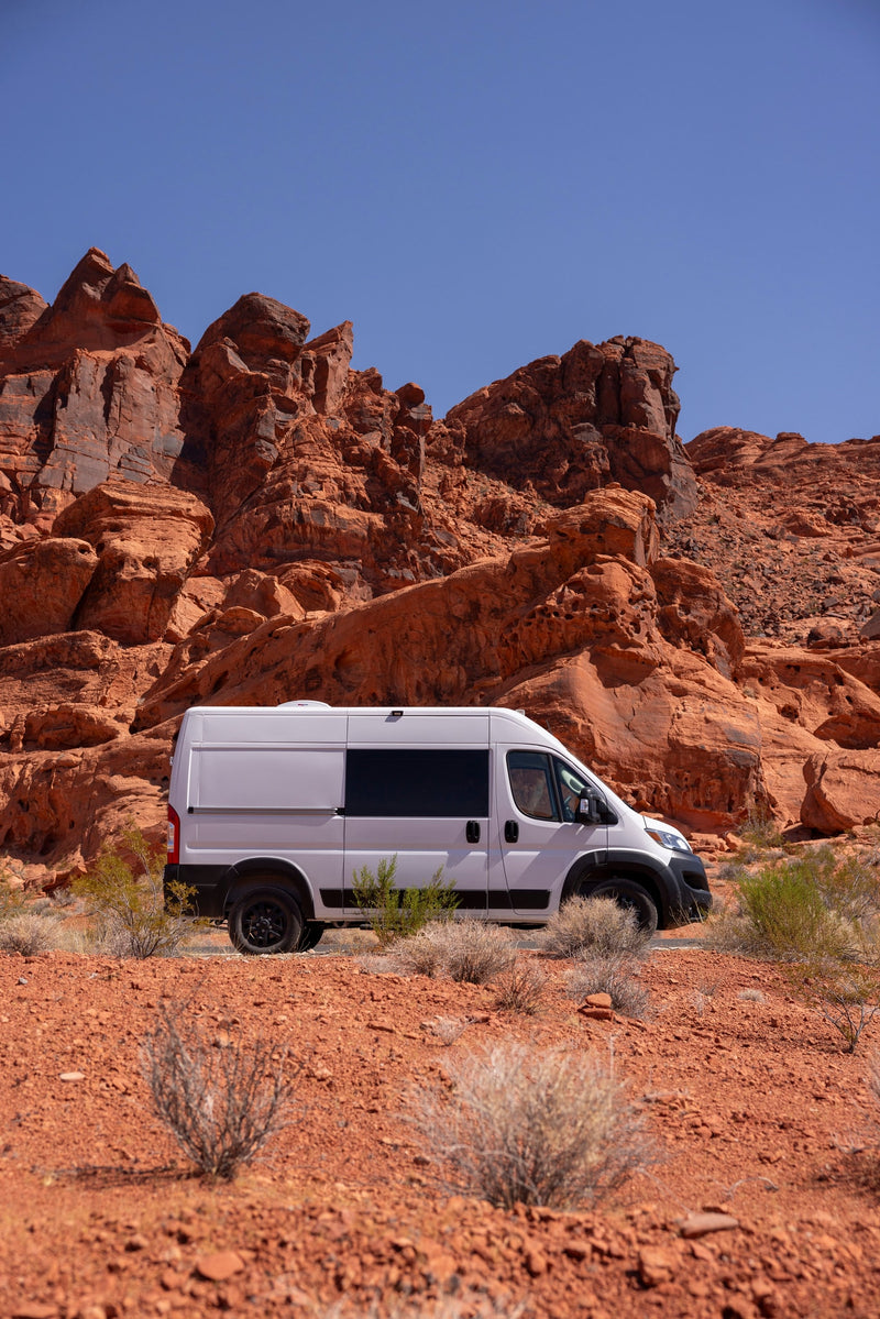 White camper van (RV rental) in a rugged red rock desert setting, ready for adventure. — photo 15