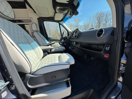 Step into this RV rental van's interior: luxurious quilted seating, modern dashboard, ready for comfortable journeys.