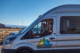 Smiling friends on a scenic outdoor RV rental adventure in their Wandervans van.