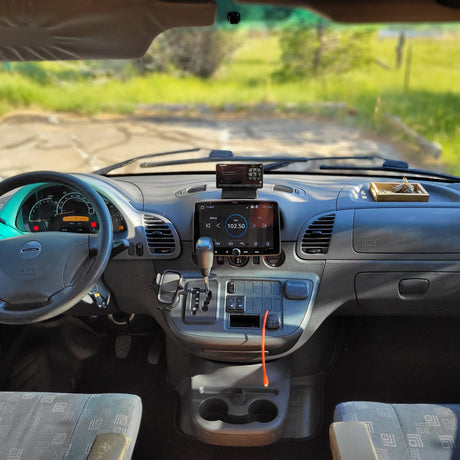 Dashboard of a Dodge RV rental, showing infotainment, SiriusXM radio, and cup holders, ready for your next road trip adventure.