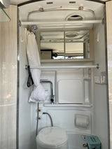 **RV rental** compact wet bath with white toilet, sink, and shower, designed for space efficiency.