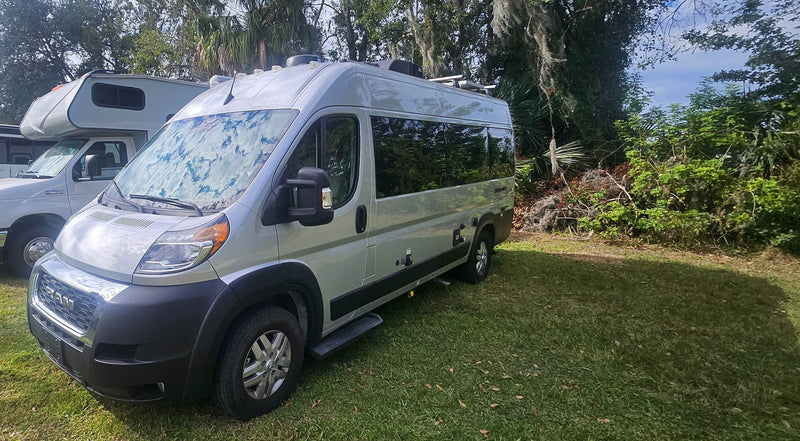  ready for outdoor adventure.|Silver Ram ProMaster camper van RV rental on green grass — photo 2