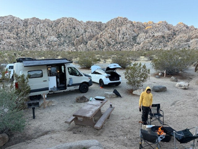  and mountains. Ready for adventure!|Custom **rv rental** van showcasing rear modular panels and roof rack equipment — photo 5