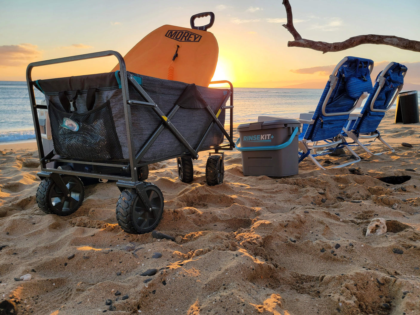 Enjoying a serene sunset at the beach, complete with a boogie board, wagon, and chairs—perfect for an RV rental adventure.