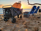Enjoying a serene sunset at the beach, complete with a boogie board, wagon, and chairs—perfect for an RV rental adventure.