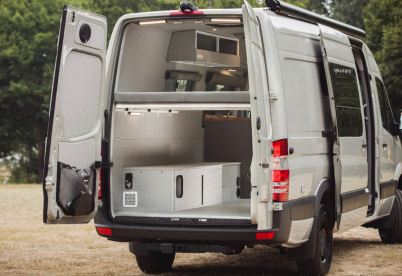 Customized RV rental camper van with open rear doors reveals its interior, including a bunk bed & ample storage. — photo 4