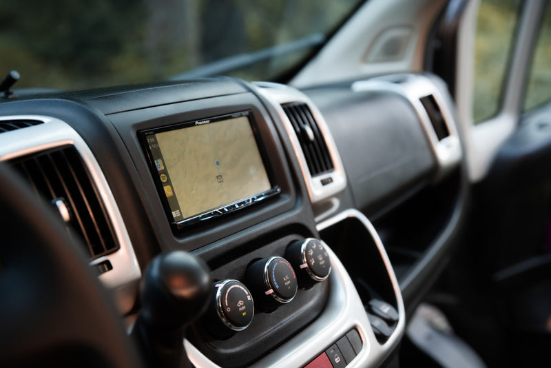 Inside an RV rental: a modern dashboard featuring a Pioneer navigation touchscreen, climate control dials, and air vents. — photo 14