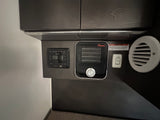 RV rental interior: integrated heater, AC fan switch, and multimedia panel with a safety warning. For comfort & control.