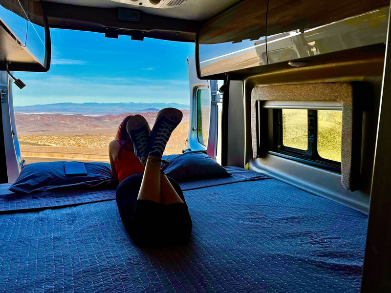 Relaxing in a comfortable RV rental, enjoying vast desert views from the open camper van doors. — photo 2